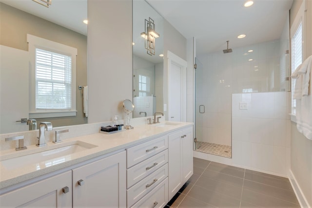 full bath with tile patterned floors, a stall shower, double vanity, and a sink