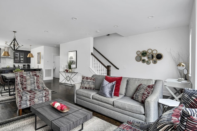 living area with stairway, recessed lighting, wood finished floors, and visible vents