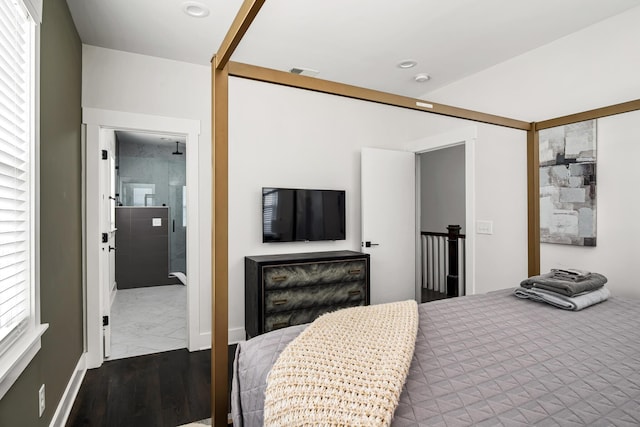 bedroom with wood finished floors, recessed lighting, visible vents, and ensuite bathroom