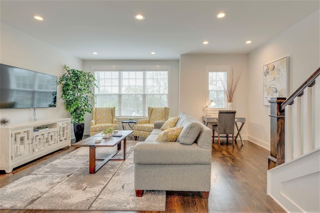 living room featuring wood finished floors, stairway, and recessed lighting