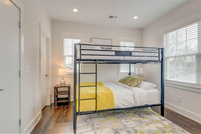 bedroom with recessed lighting, wood finished floors, visible vents, and baseboards