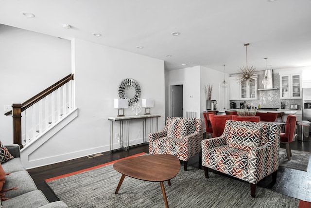 living area with visible vents, dark wood-style floors, recessed lighting, stairway, and baseboards