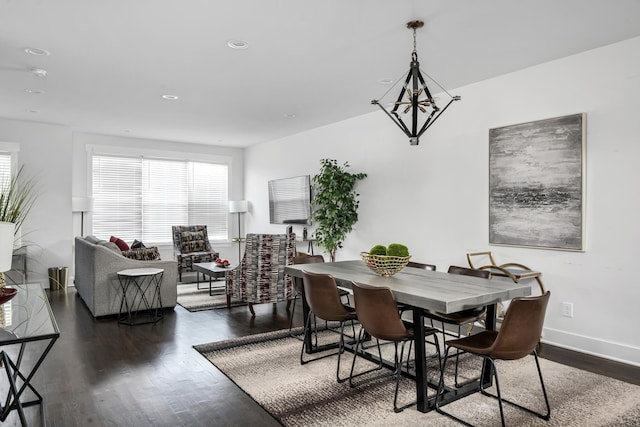 dining space with a notable chandelier, wood finished floors, and a wealth of natural light