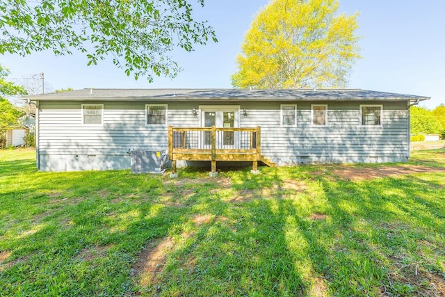 rear view of property with crawl space, a yard, central AC unit, and a deck