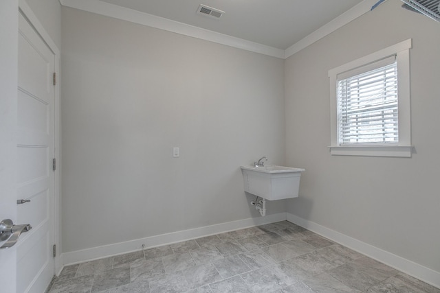 laundry area featuring crown molding, baseboards, and visible vents