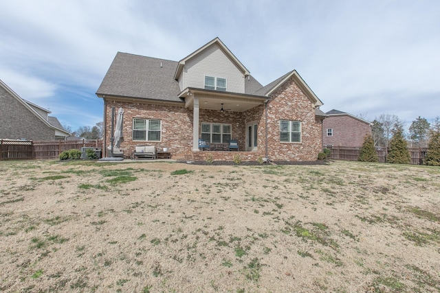 back of property featuring brick siding, a patio, a ceiling fan, and a fenced backyard