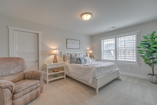 bedroom with visible vents, light colored carpet, and baseboards