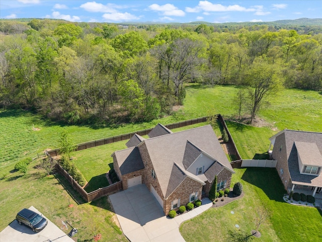 drone / aerial view with a wooded view