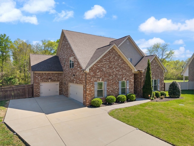 view of front of home with brick siding, driveway, a front lawn, and fence