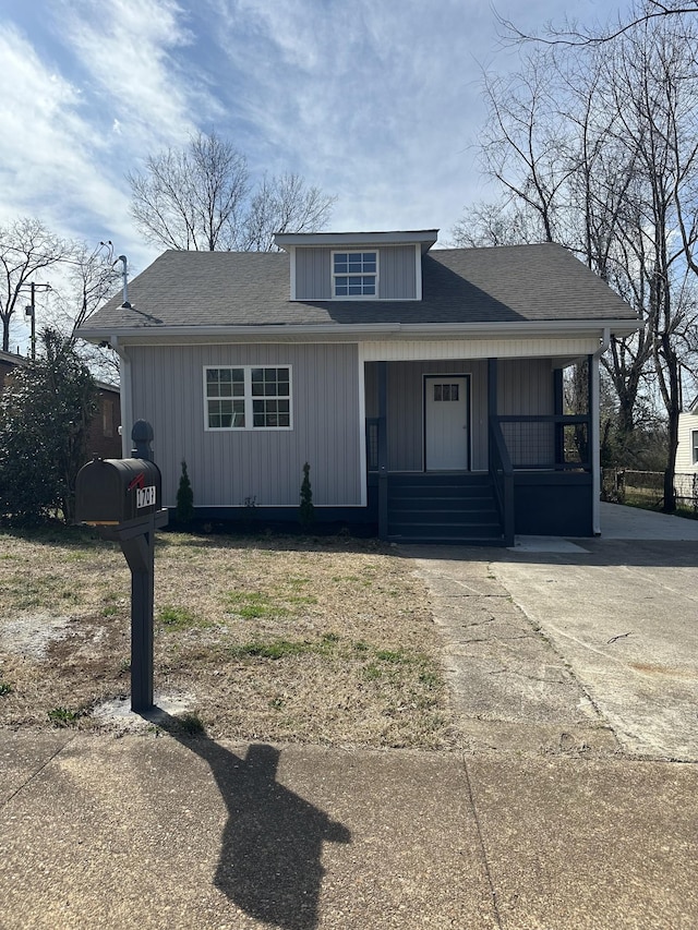 bungalow-style house with roof with shingles and covered porch