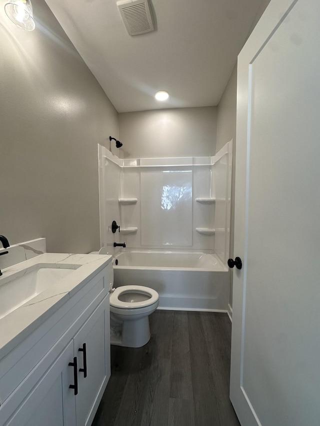 full bath with vanity, wood finished floors, visible vents, shower / bath combination, and toilet