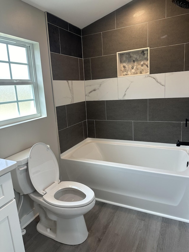 full bath featuring vanity, shower / tub combination, toilet, and wood finished floors