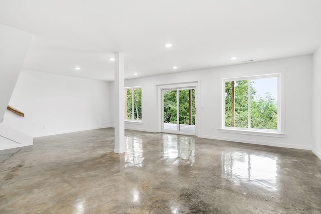 unfurnished room with recessed lighting, baseboards, and finished concrete floors