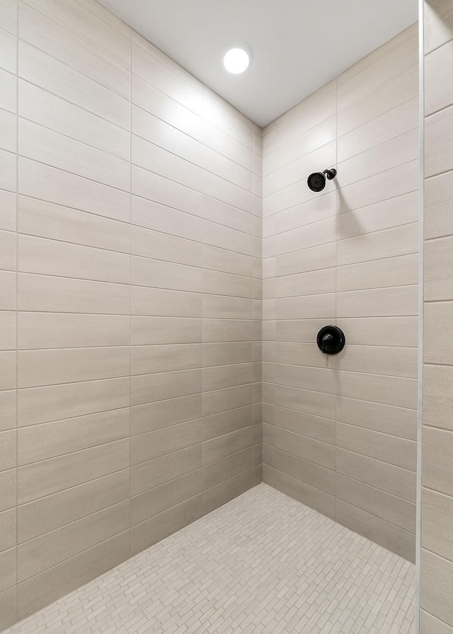 bathroom with tiled shower