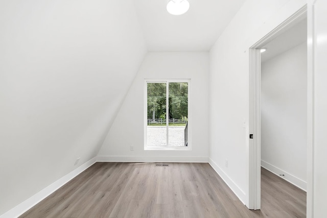 interior space featuring visible vents, light wood-style flooring, and baseboards