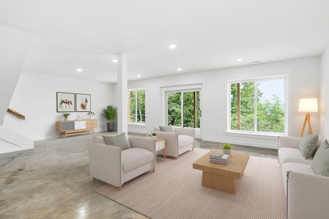 living room featuring recessed lighting and finished concrete flooring