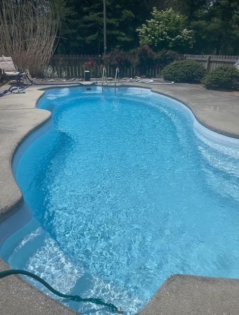 view of swimming pool featuring a patio area, a fenced in pool, and a fenced backyard