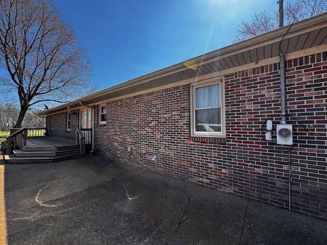 view of property exterior with brick siding