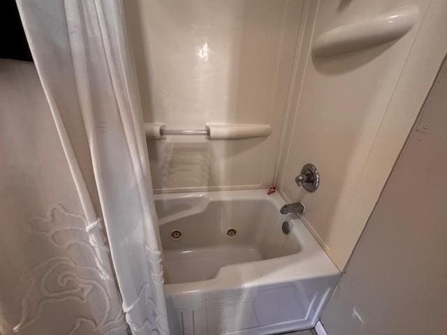 full bath with a combined bath / shower with jetted tub