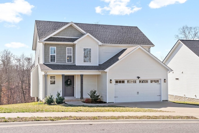 traditional home featuring a garage, concrete driveway, a front yard, and a shingled roof