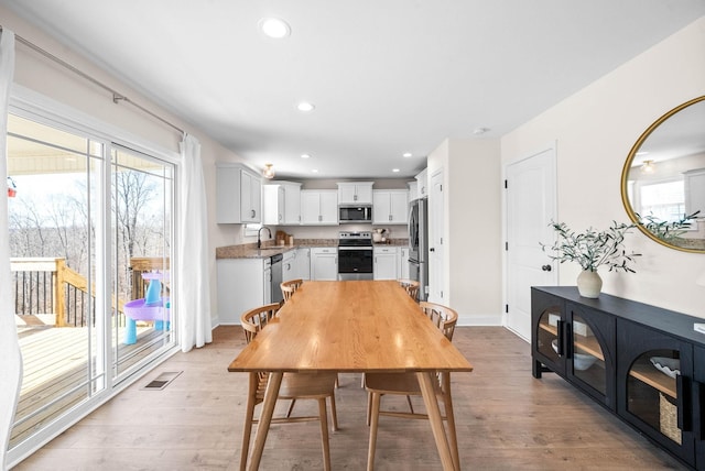 dining space with recessed lighting, visible vents, and light wood-type flooring