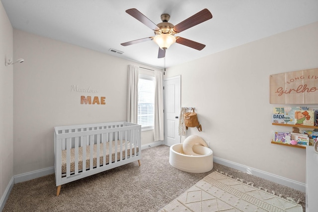 bedroom with visible vents, baseboards, ceiling fan, carpet flooring, and a nursery area