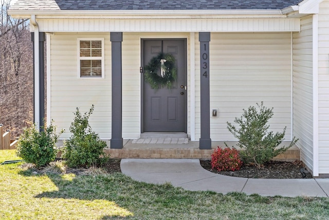 entrance to property featuring roof with shingles