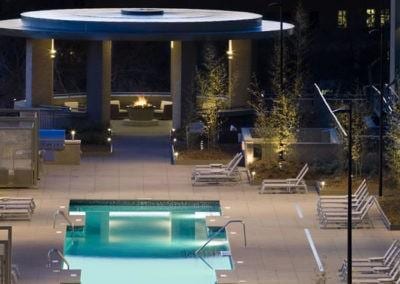 community pool with an outdoor fire pit and a patio