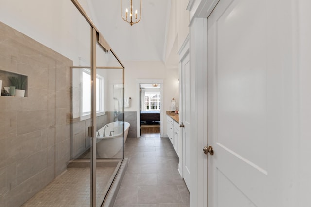 full bath featuring a soaking tub, tile patterned flooring, a shower stall, tile walls, and a chandelier