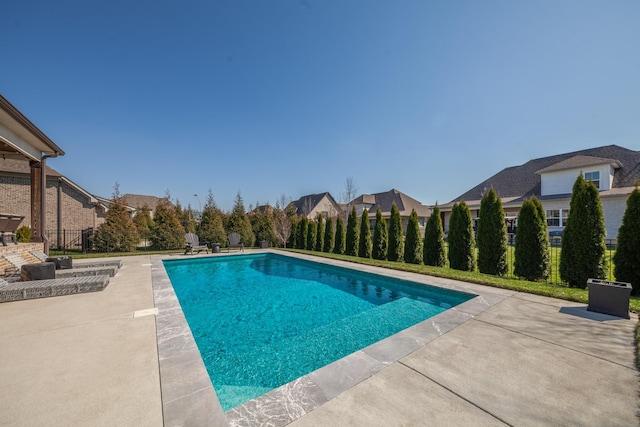 view of swimming pool with a patio area, a fenced in pool, and fence