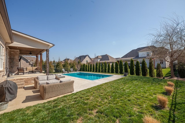 view of pool with a ceiling fan, an outdoor living space, a patio, a fenced backyard, and a yard