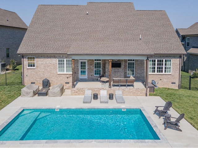 view of swimming pool featuring a fenced in pool, a patio, a lawn, and fence