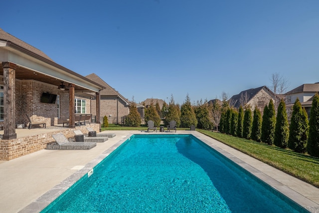 view of swimming pool featuring a ceiling fan, a fenced in pool, a patio area, and fence