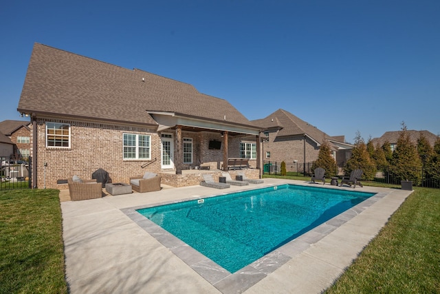 view of swimming pool with a patio area, an outdoor living space, a lawn, and a fenced backyard