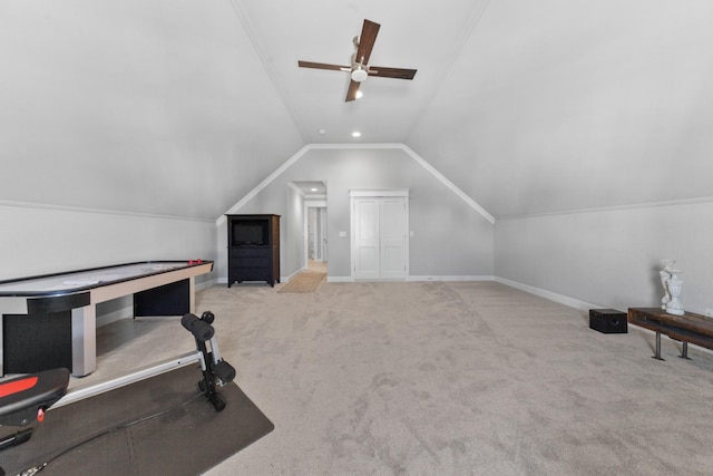 interior space with lofted ceiling, crown molding, carpet flooring, and a ceiling fan