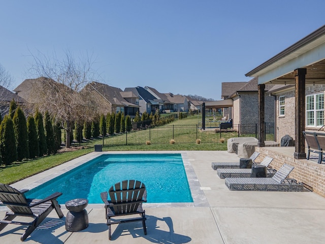 view of swimming pool with a yard, a residential view, a fenced in pool, fence private yard, and a patio area