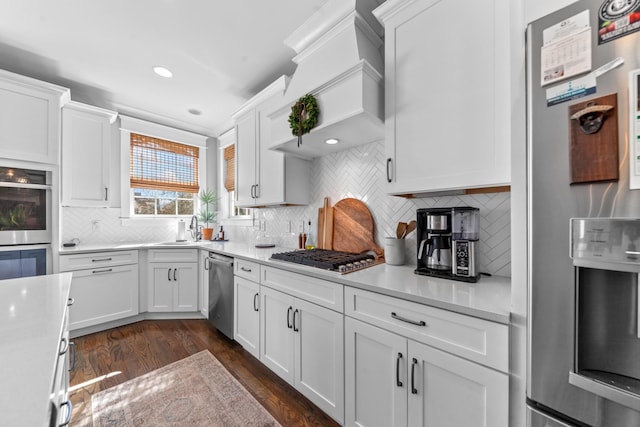 kitchen with white cabinets, appliances with stainless steel finishes, and light countertops