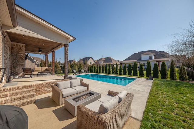 view of swimming pool with a patio, a fenced in pool, a yard, ceiling fan, and an outdoor living space with a fire pit