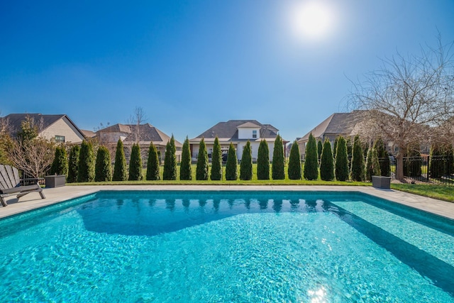 view of swimming pool featuring a fenced in pool and fence