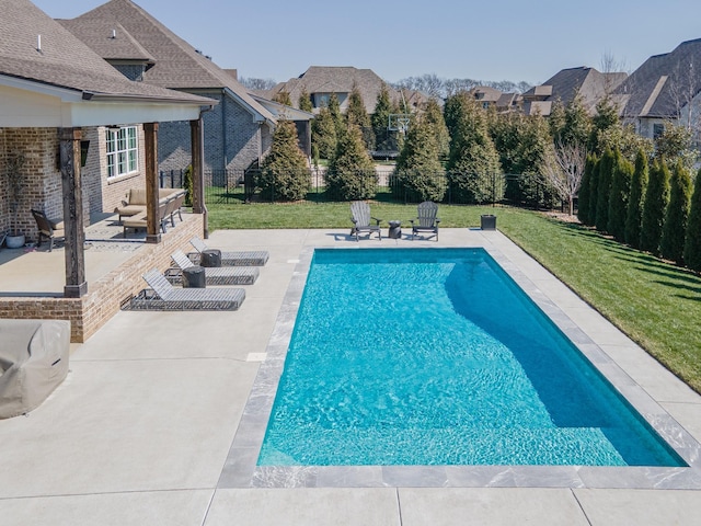 pool featuring a patio area, a yard, a fenced backyard, and an outdoor living space