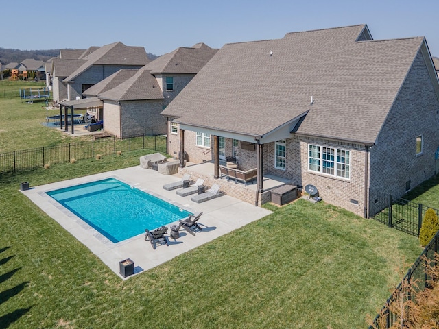 view of pool featuring a fenced in pool, a lawn, a fenced backyard, and a patio area