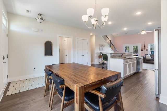 dining room featuring visible vents, dark wood-type flooring, baseboards, recessed lighting, and ceiling fan with notable chandelier