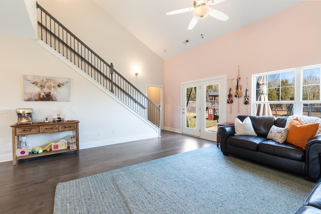 living area featuring a ceiling fan, baseboards, high vaulted ceiling, dark wood-style flooring, and stairs