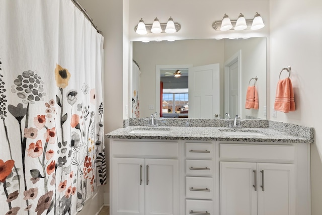 bathroom featuring a sink, a shower with curtain, a ceiling fan, and double vanity