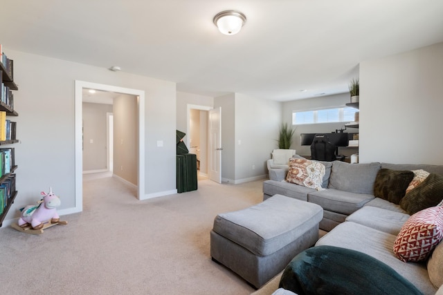 living area featuring light colored carpet and baseboards