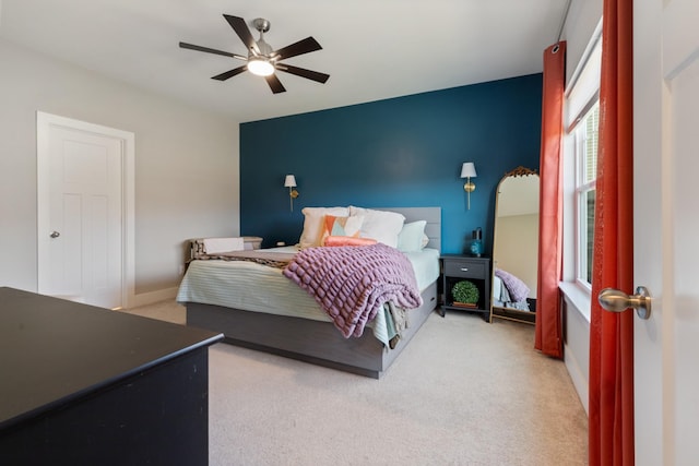 carpeted bedroom featuring baseboards and ceiling fan