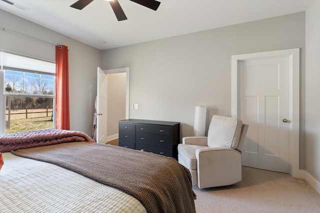 bedroom with visible vents, light carpet, baseboards, and ceiling fan