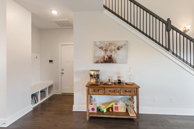 interior space featuring visible vents, baseboards, and wood finished floors