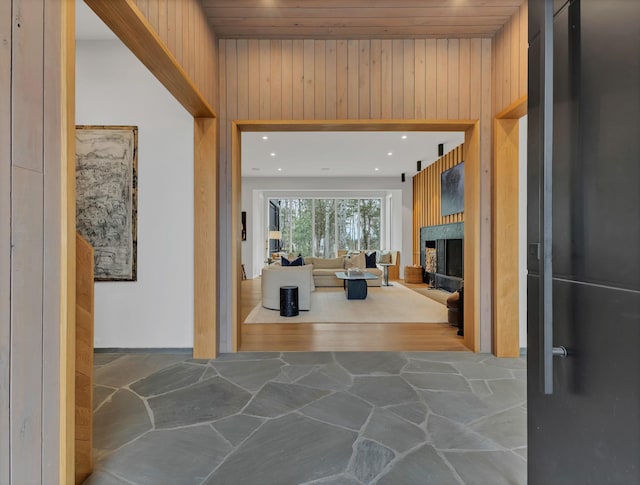 hall with stone floors and wood walls