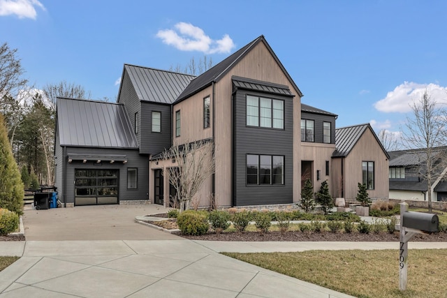 modern farmhouse style home featuring a garage, metal roof, driveway, and a standing seam roof